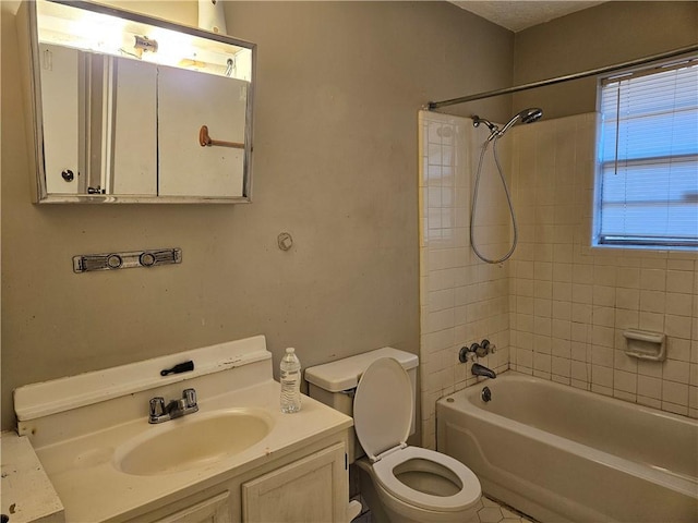 full bathroom featuring vanity, toilet, and tiled shower / bath combo