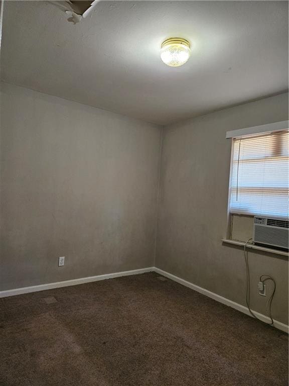 empty room with cooling unit and dark carpet