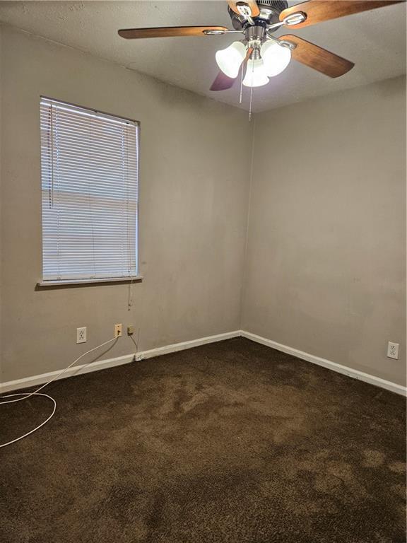 carpeted empty room with ceiling fan