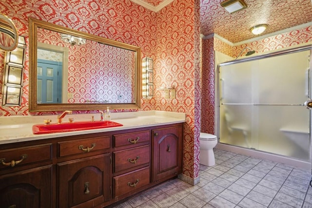 bathroom with toilet, a stall shower, vanity, and wallpapered walls