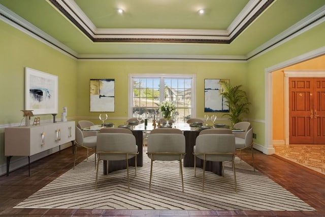 dining area featuring a raised ceiling and ornamental molding