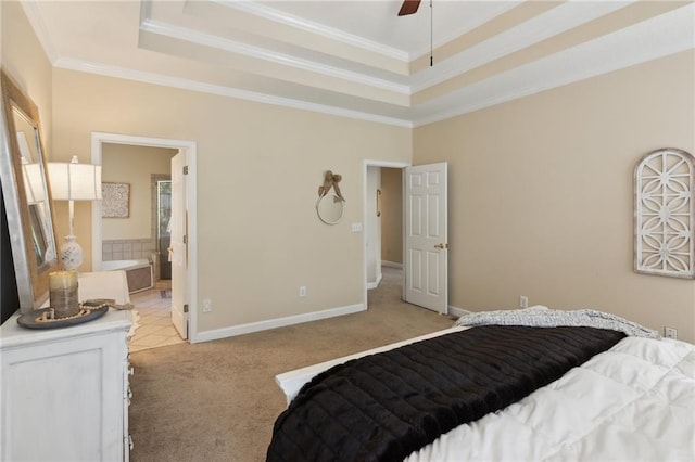 bedroom with baseboards, a raised ceiling, light colored carpet, ensuite bath, and ornamental molding