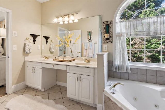 bathroom featuring plenty of natural light, tile patterned flooring, a sink, and a whirlpool tub