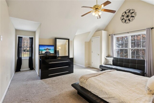 carpeted bedroom featuring baseboards, high vaulted ceiling, and ceiling fan