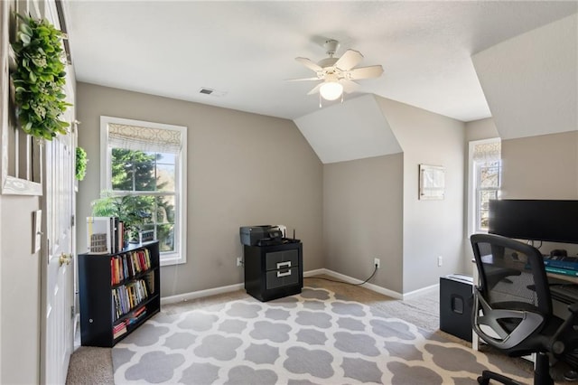 office area featuring light carpet, ceiling fan, vaulted ceiling, and baseboards