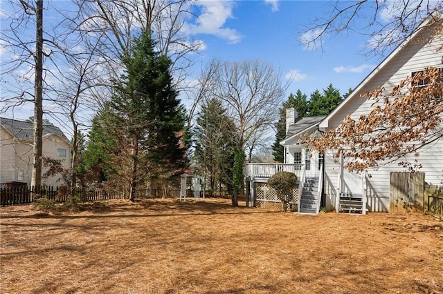 view of yard with stairway, fence, and a wooden deck