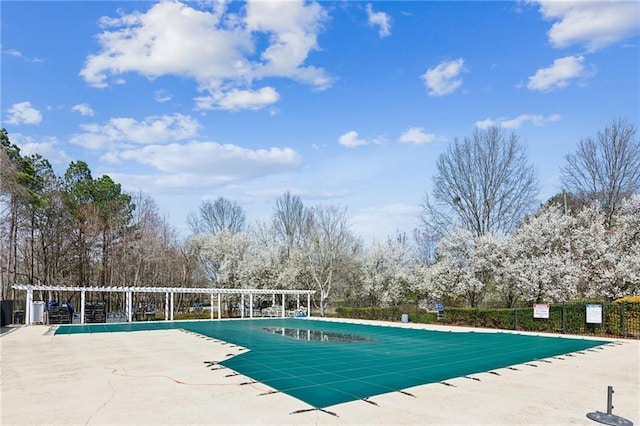 community pool with fence and a patio