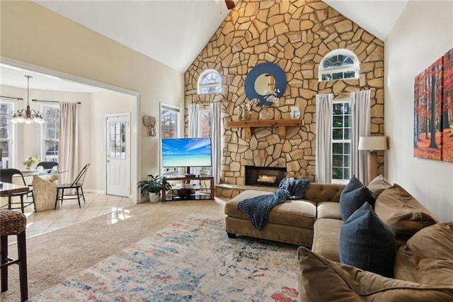 carpeted living room with baseboards, tile patterned floors, an inviting chandelier, a fireplace, and high vaulted ceiling