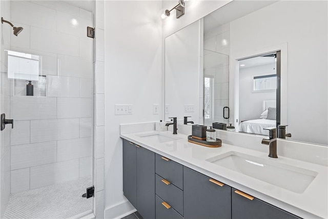 full bathroom featuring a stall shower, double vanity, a sink, and connected bathroom