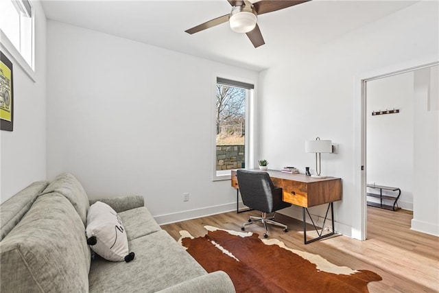 home office featuring wood finished floors, baseboards, and a ceiling fan