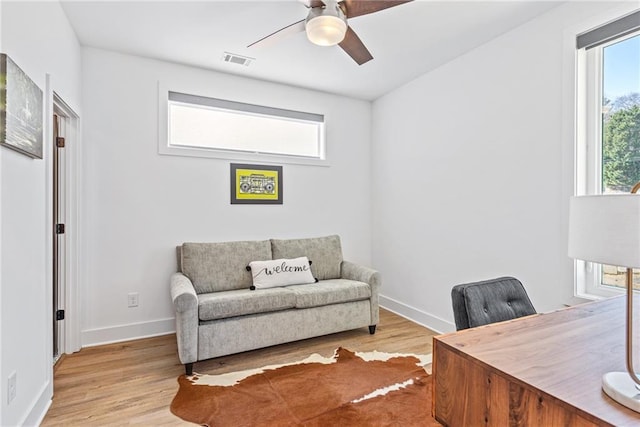 office featuring visible vents, ceiling fan, wood finished floors, and baseboards