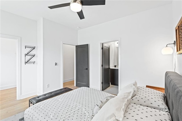 bedroom with ceiling fan, light wood finished floors, and baseboards