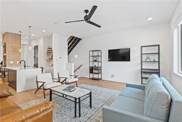 living room with baseboards, recessed lighting, light wood-style floors, a healthy amount of sunlight, and ceiling fan