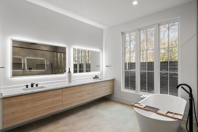 185 Pebble Trl, Alpharetta, GA 30009 - bathroom featuring double vanity, a soaking tub, baseboards, and recessed lighting