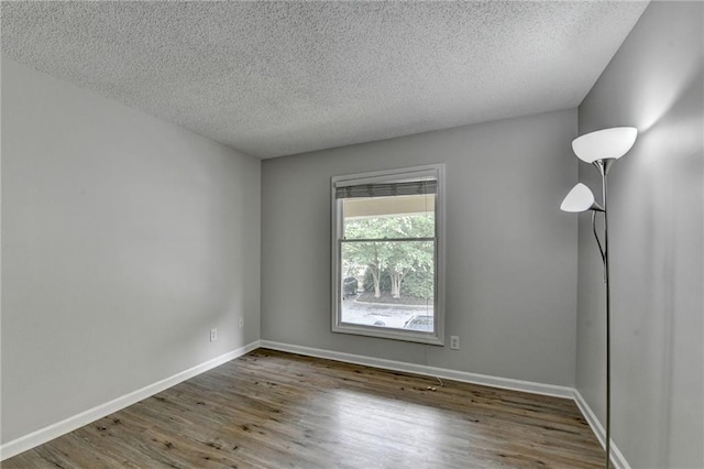 3650 Ashford Dunwoody Rd NE Unit 923, Atlanta, GA 30319 - spare room with wood finished floors, a textured ceiling, and baseboards