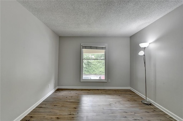 3650 Ashford Dunwoody Rd NE Unit 923, Atlanta, GA 30319 - unfurnished room featuring a textured ceiling, wood finished floors, and baseboards