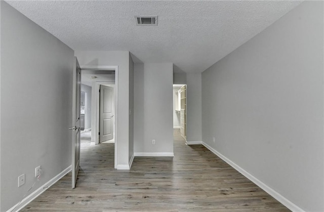 3650 Ashford Dunwoody Rd NE Unit 923, Atlanta, GA 30319 - spare room with wood finished floors, a textured ceiling, and baseboards
