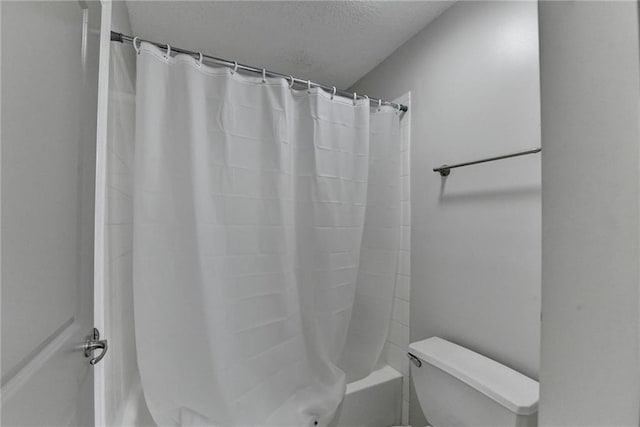 3650 Ashford Dunwoody Rd NE Unit 923, Atlanta, GA 30319 - bathroom featuring toilet, shower / tub combo with curtain, and a textured ceiling