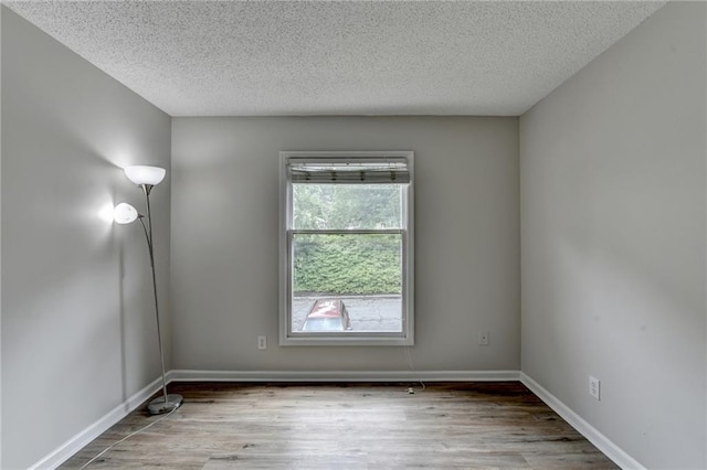 3650 Ashford Dunwoody Rd NE Unit 923, Atlanta, GA 30319 - unfurnished room with wood finished floors, a textured ceiling, and baseboards