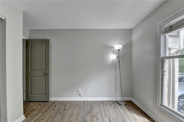 3650 Ashford Dunwoody Rd NE Unit 923, Atlanta, GA 30319 - spare room with wood finished floors, a textured ceiling, and baseboards