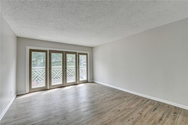 3650 Ashford Dunwoody Rd NE Unit 923, Atlanta, GA 30319 - unfurnished room with wood finished floors, a textured ceiling, and baseboards