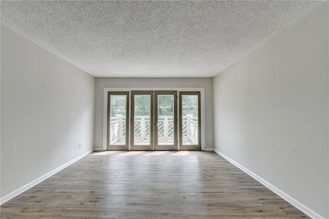 3650 Ashford Dunwoody Rd NE Unit 923, Atlanta, GA 30319 - spare room with a textured ceiling, wood finished floors, and baseboards