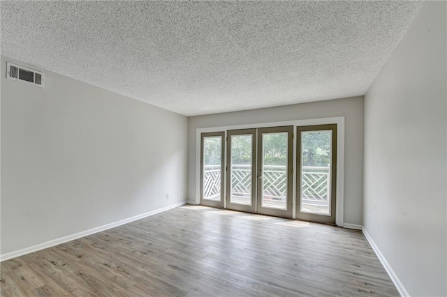 3650 Ashford Dunwoody Rd NE Unit 923, Atlanta, GA 30319 - spare room featuring a textured ceiling, wood finished floors, and baseboards