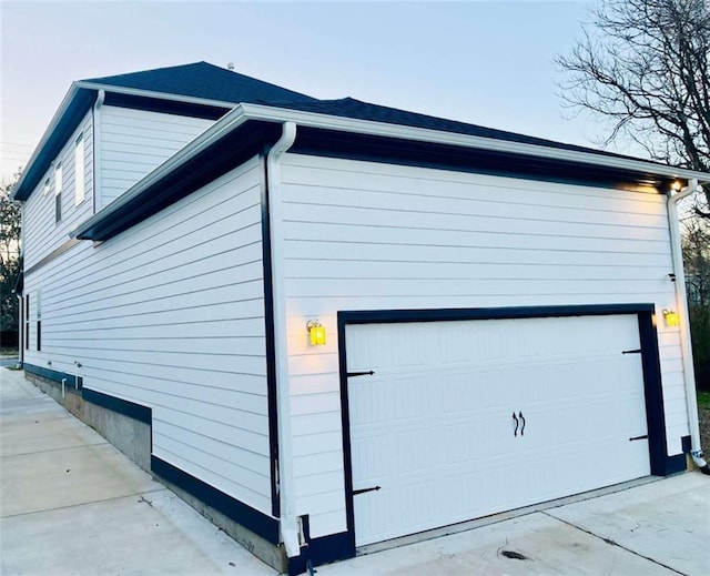 view of side of home featuring a garage