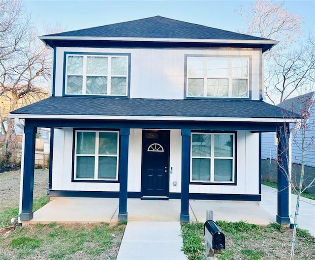 view of front of house featuring covered porch, a shingled roof, and board and batten siding