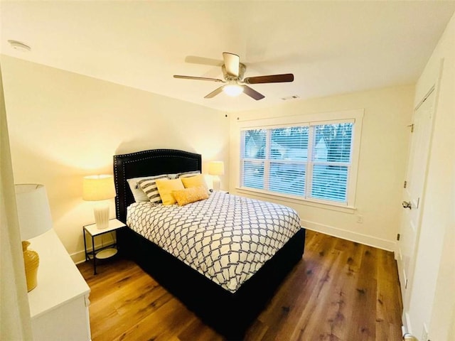 bedroom featuring visible vents, baseboards, and dark wood-style flooring