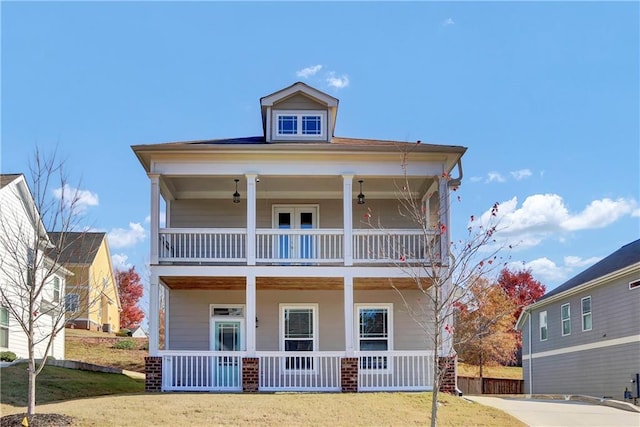 view of front of property with a balcony and a front yard