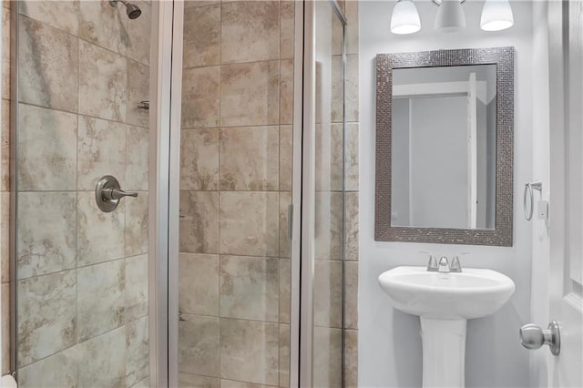 bathroom with walk in shower and sink