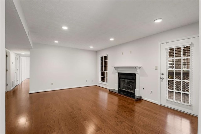 unfurnished living room with hardwood / wood-style flooring