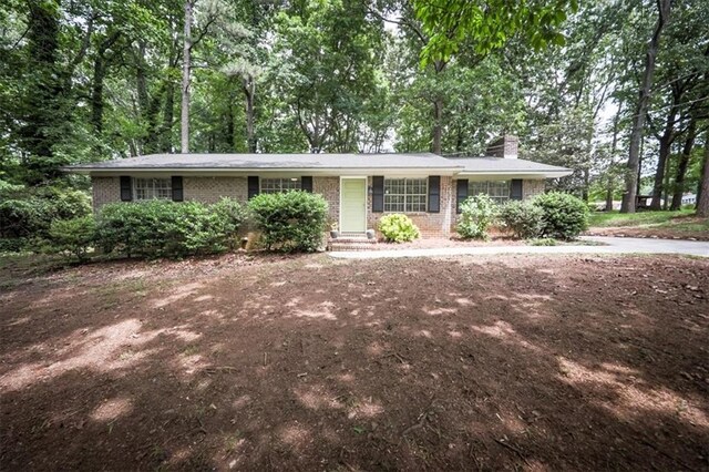 5666 Goldfield Dr, Acworth, GA 30102 - ranch-style home with brick siding, a chimney, and driveway