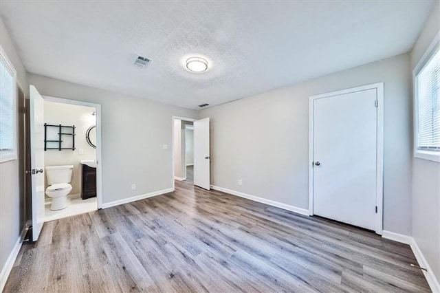 5666 Goldfield Dr, Acworth, GA 30102 - unfurnished bedroom with wood finished floors, baseboards, and a textured ceiling