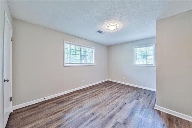 5666 Goldfield Dr, Acworth, GA 30102 - unfurnished bedroom featuring wood finished floors, baseboards, and a textured ceiling