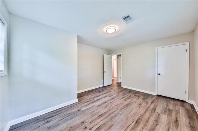 5666 Goldfield Dr, Acworth, GA 30102 - unfurnished bedroom featuring wood finished floors, baseboards, and multiple windows