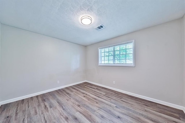 5666 Goldfield Dr, Acworth, GA 30102 - spare room featuring wood finished floors, baseboards, and a textured ceiling