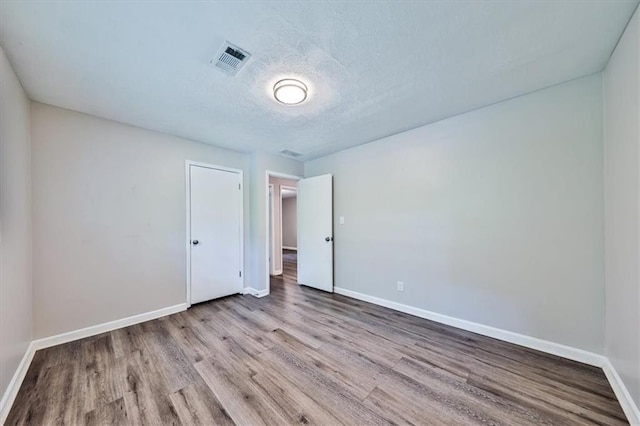 5666 Goldfield Dr, Acworth, GA 30102 - unfurnished bedroom featuring wood finished floors, baseboards, and a textured ceiling