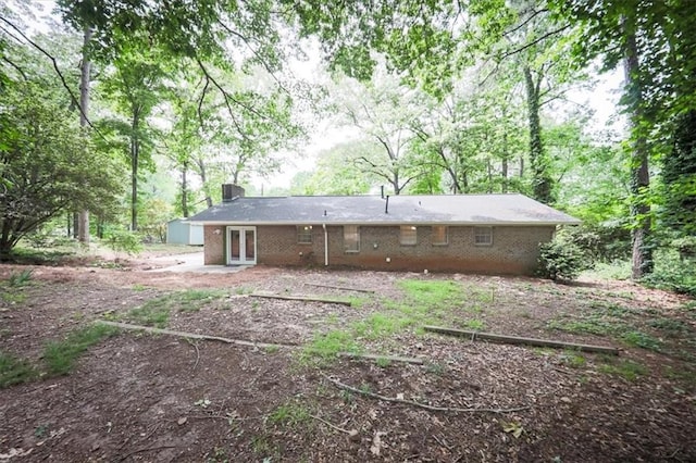 5666 Goldfield Dr, Acworth, GA 30102 - back of house with french doors, brick siding, a chimney, and a patio area