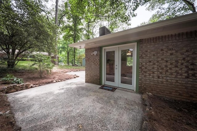 5666 Goldfield Dr, Acworth, GA 30102 - entrance to property featuring brick siding, french doors, a chimney, and a patio