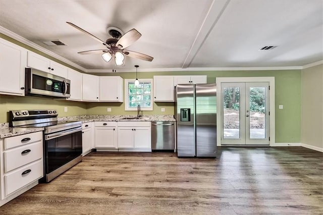 5666 Goldfield Dr, Acworth, GA 30102 - kitchen featuring appliances with stainless steel finishes, crown molding, wood finished floors, french doors, and white cabinets