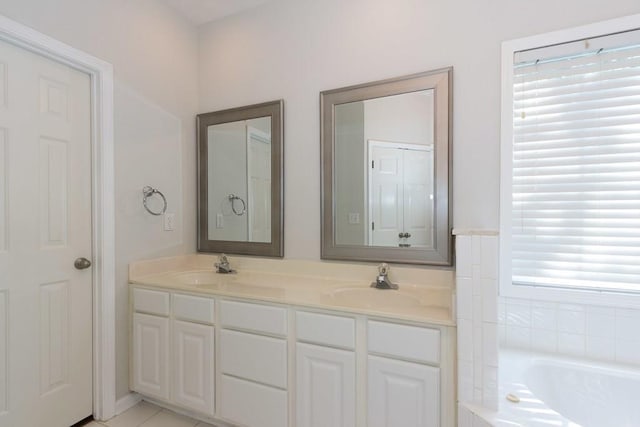 bathroom featuring vanity and a relaxing tiled tub