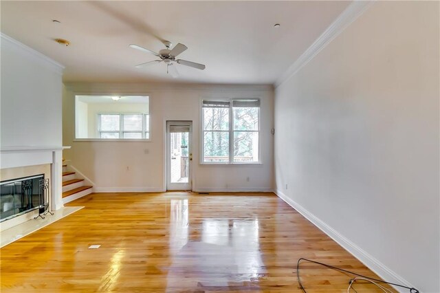 unfurnished living room featuring ceiling fan, light hardwood / wood-style flooring, and crown molding