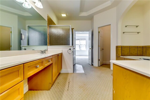 bathroom with vanity and a shower with shower door