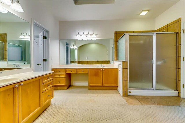 bathroom featuring vanity and an enclosed shower