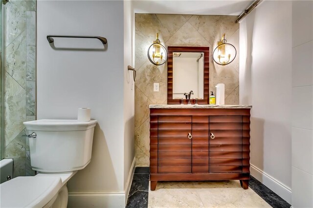 bathroom featuring tile walls, vanity, and toilet