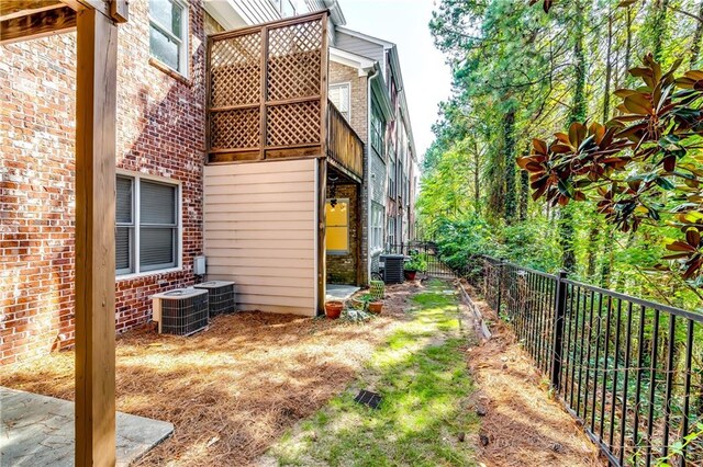 view of side of home featuring central AC