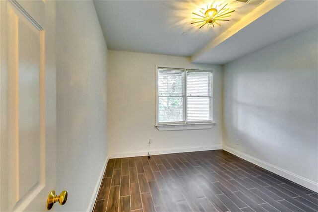 unfurnished room featuring dark hardwood / wood-style floors