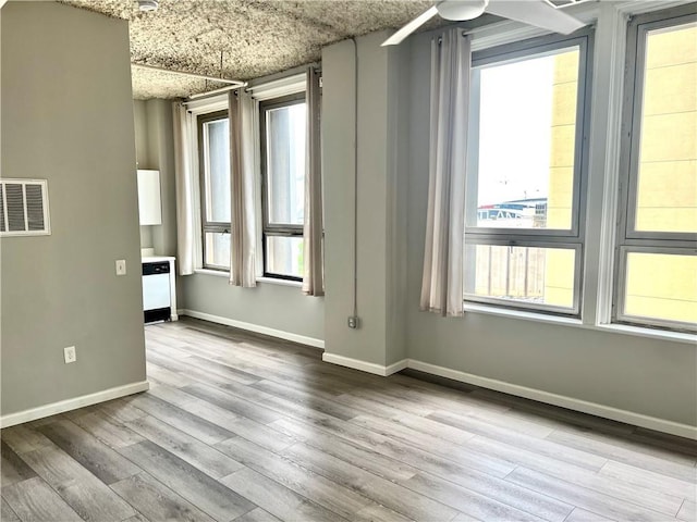 empty room with wood finished floors and baseboards